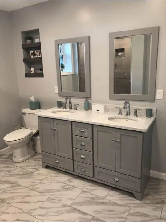 Bathroom with a gray double vanity and marble-look tile floor
