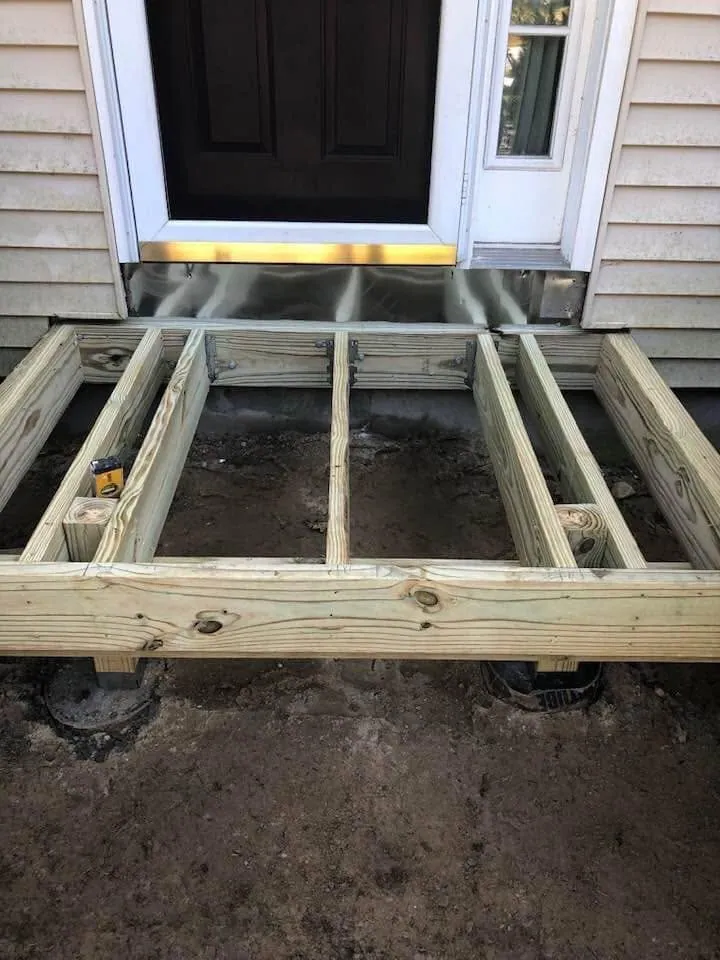 Front step framing in progress at an entry door